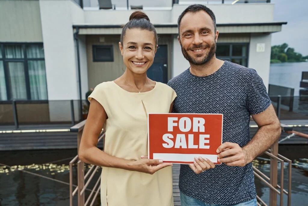 Selling your home in Las Vegas - happy couple sell sign